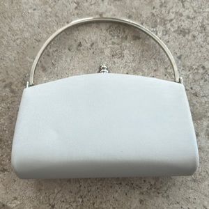 White cloth clutch with silver handle and option for chain shoulder strap